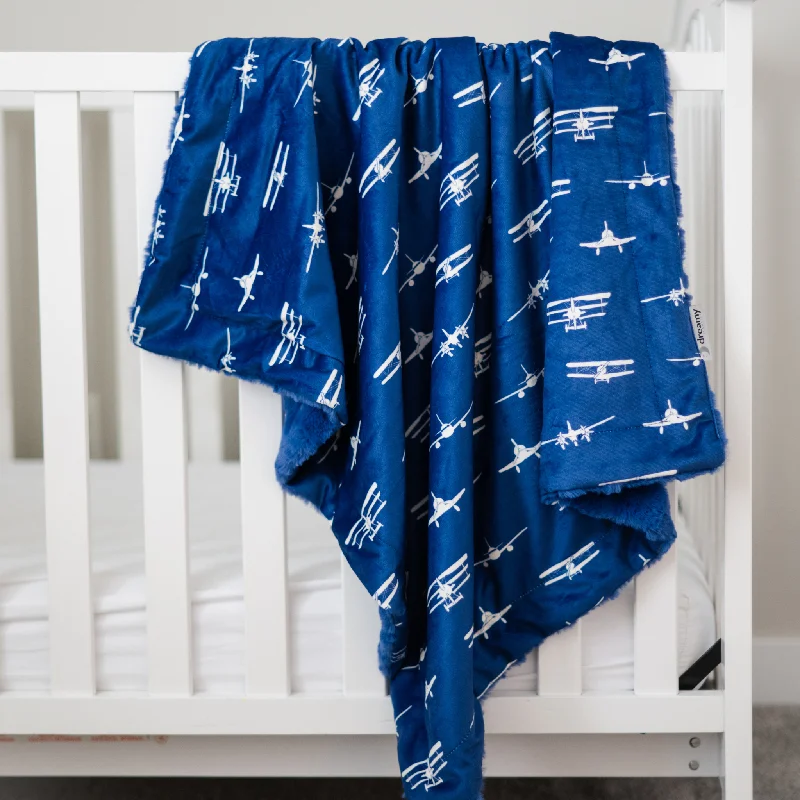 Cotton blankets for breathability and a lightweight feelAirplanes Take Flight Navy Baby Blanket